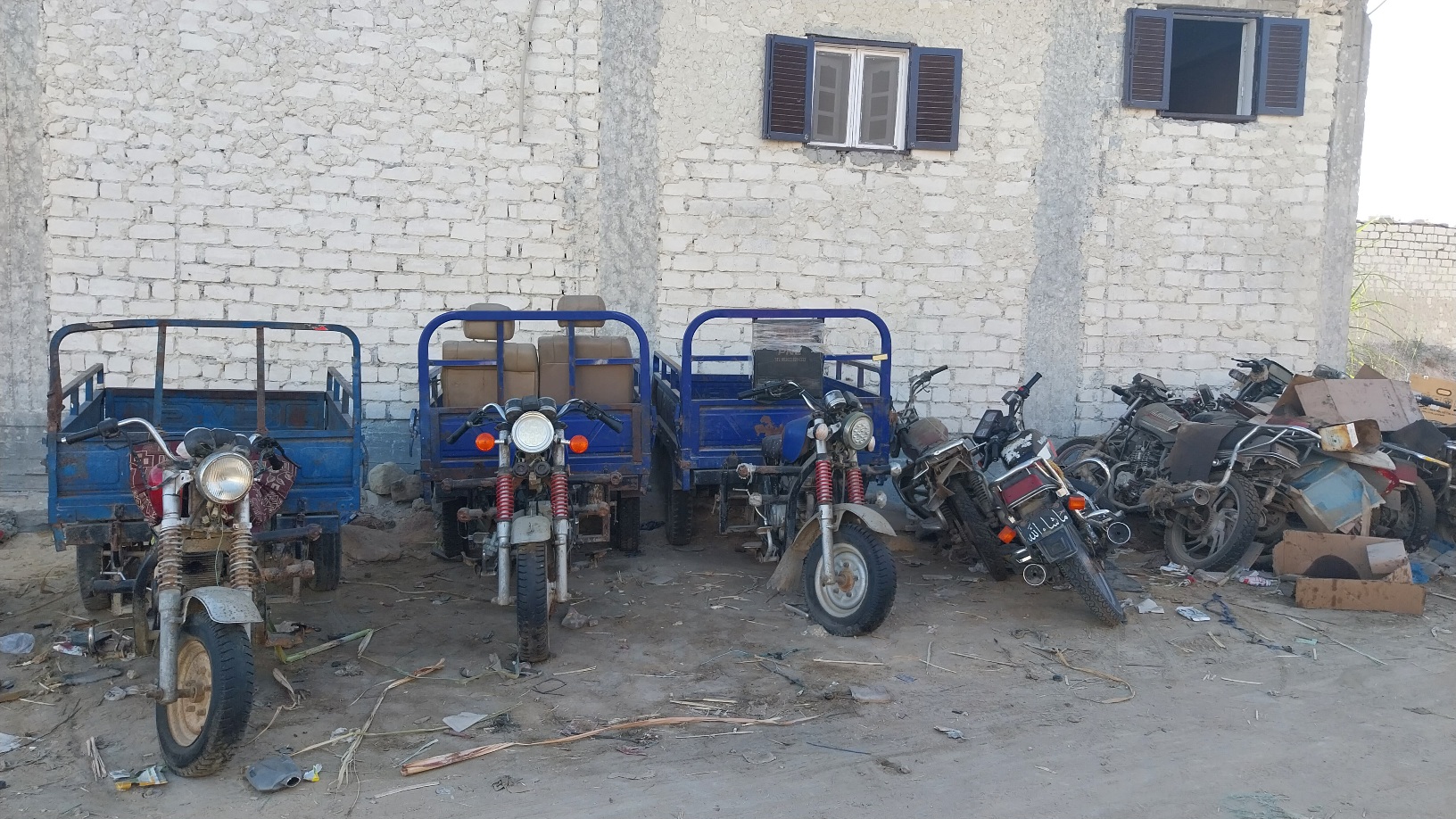a display of half-working tuktuks and small motorbikes
